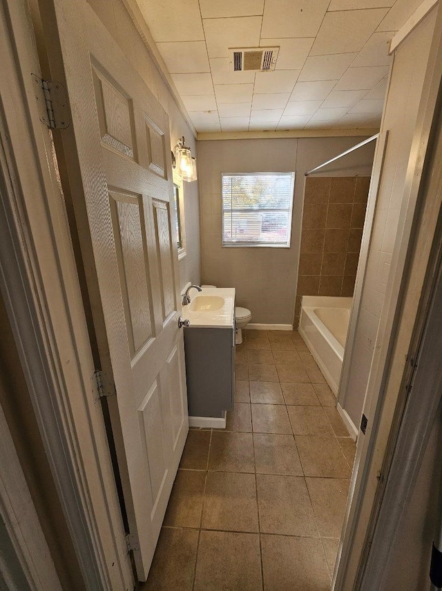 full bathroom with tub / shower combination, tile patterned floors, vanity, and toilet