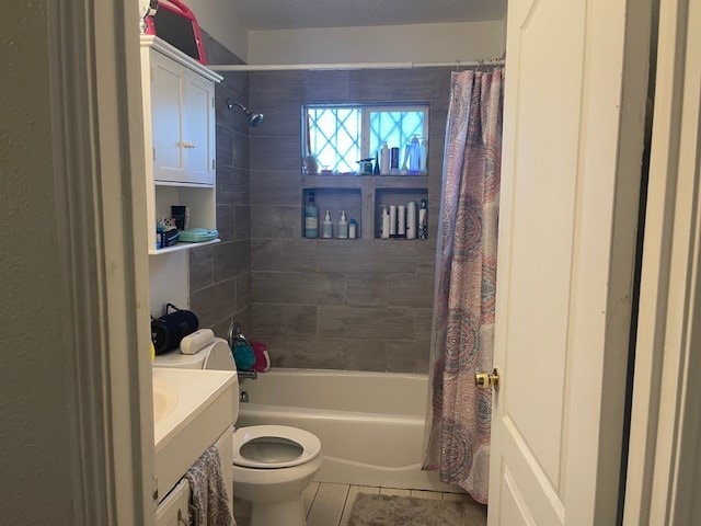 full bathroom featuring tile patterned floors, vanity, toilet, and shower / tub combo