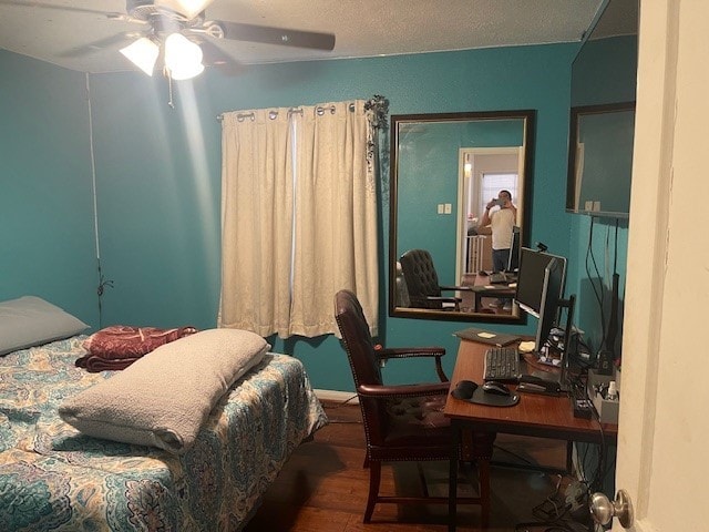 bedroom featuring ceiling fan and dark hardwood / wood-style floors