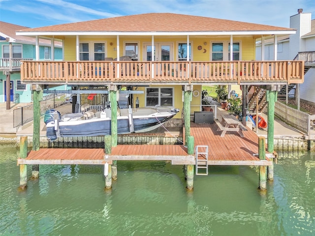 rear view of house featuring a water view