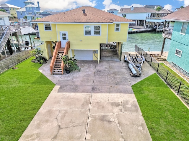 rear view of house featuring a garage and a lawn