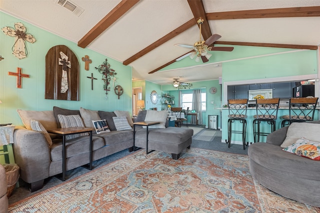 carpeted living room featuring ceiling fan, beam ceiling, and high vaulted ceiling