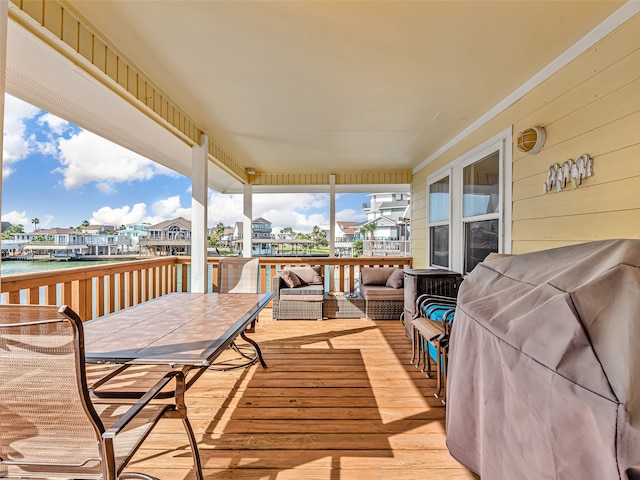 wooden deck featuring a grill and an outdoor hangout area