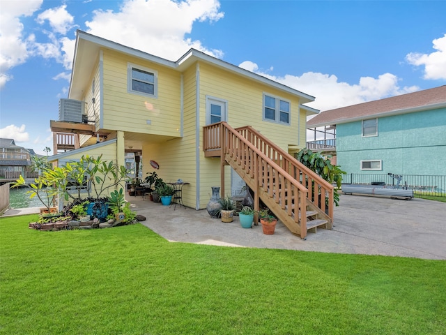 back of house with a patio, central AC, and a yard