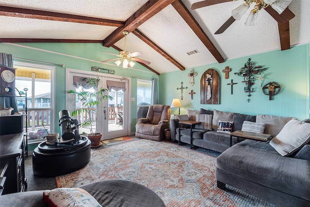 living room featuring carpet, ceiling fan, vaulted ceiling with beams, french doors, and a textured ceiling