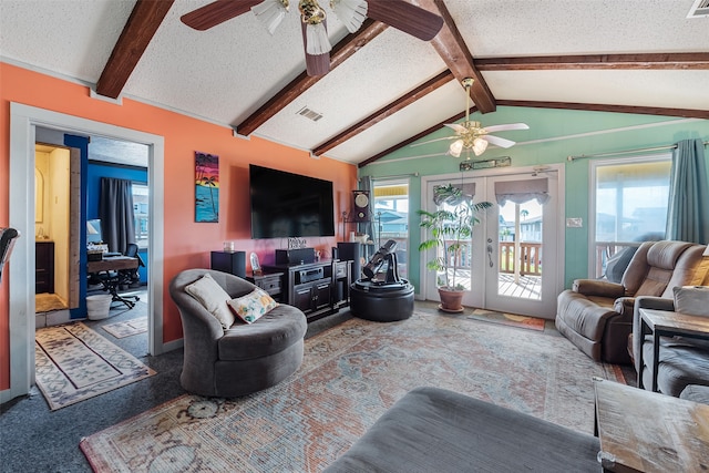 carpeted living room with ceiling fan, lofted ceiling with beams, and a textured ceiling