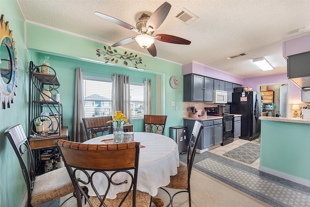 dining space featuring ceiling fan, a textured ceiling, and light tile floors