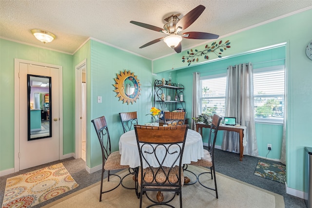 carpeted dining area with ceiling fan, a textured ceiling, and crown molding