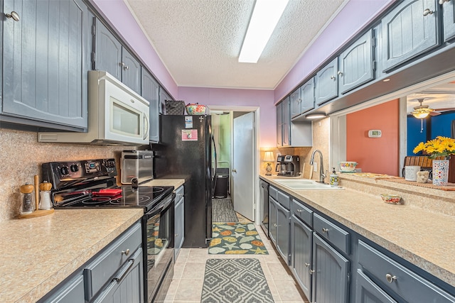 kitchen with ceiling fan, electric stove, a textured ceiling, light tile floors, and sink