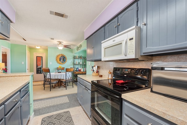 kitchen with ceiling fan, a textured ceiling, black range with electric cooktop, and light tile floors