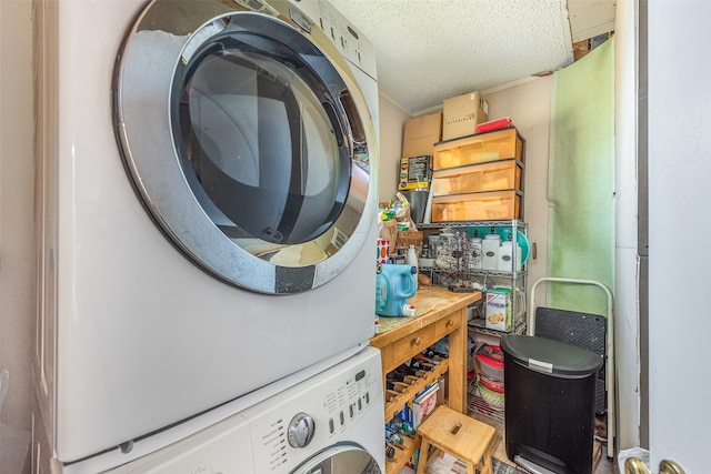 washroom with stacked washing maching and dryer and a textured ceiling