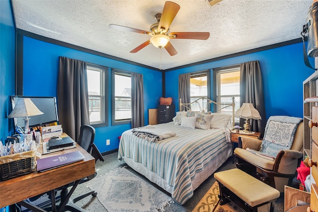 carpeted bedroom featuring ceiling fan and a textured ceiling