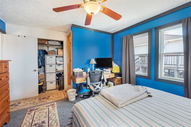 bedroom with a closet, ceiling fan, and a textured ceiling