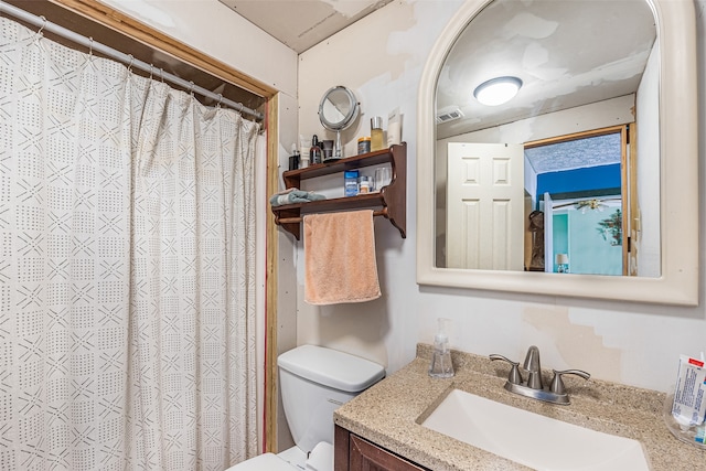 bathroom featuring oversized vanity and toilet