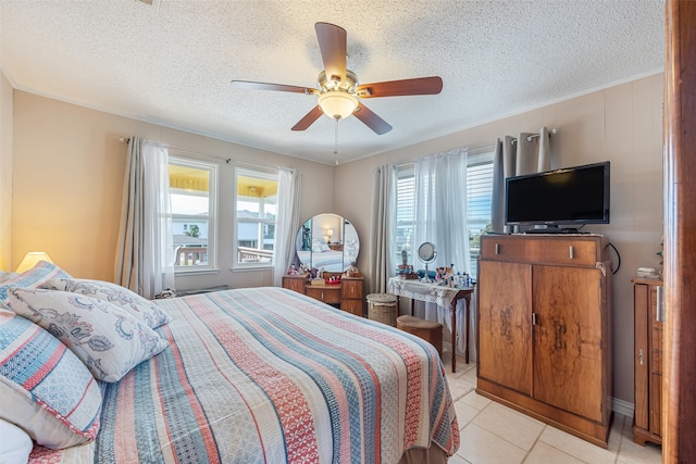 tiled bedroom featuring ceiling fan and a textured ceiling