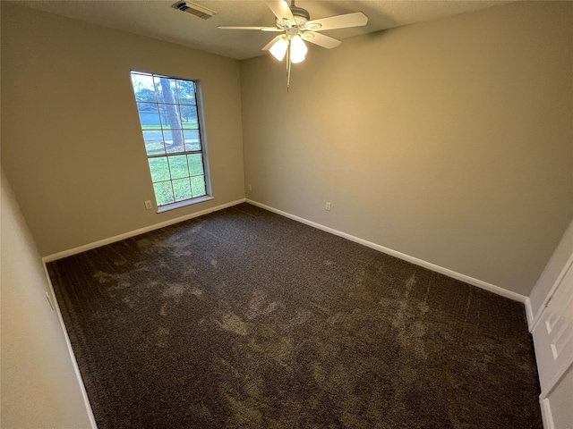 carpeted spare room with ceiling fan