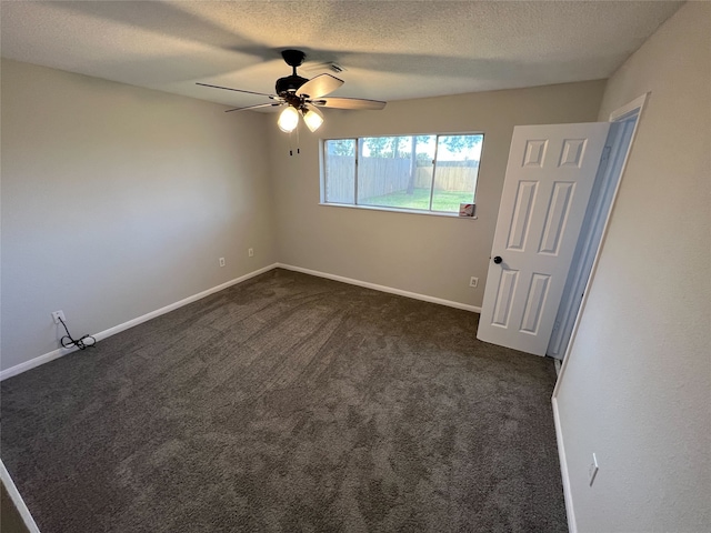 carpeted spare room with a textured ceiling and ceiling fan