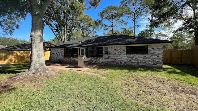 back of property featuring a yard and a patio area