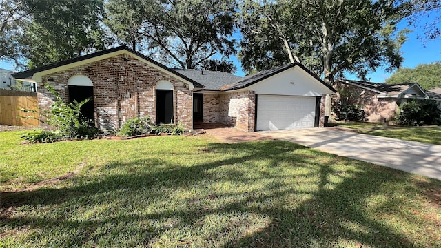 single story home featuring a garage and a front yard