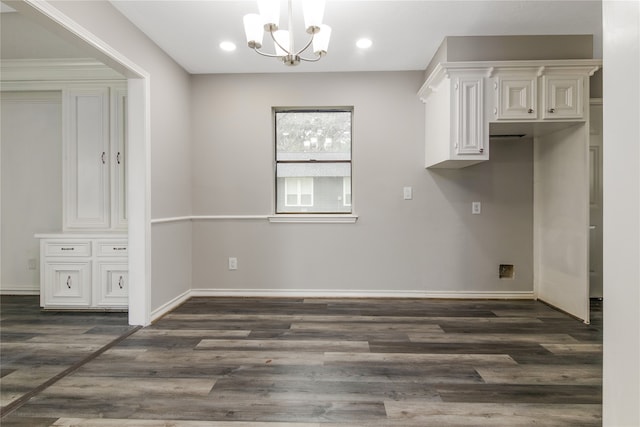 interior space with a notable chandelier and dark hardwood / wood-style flooring