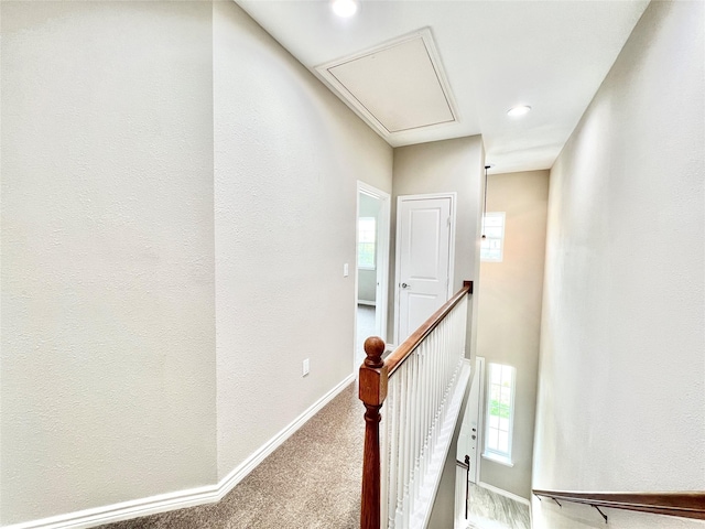 corridor with carpet, baseboards, attic access, recessed lighting, and an upstairs landing