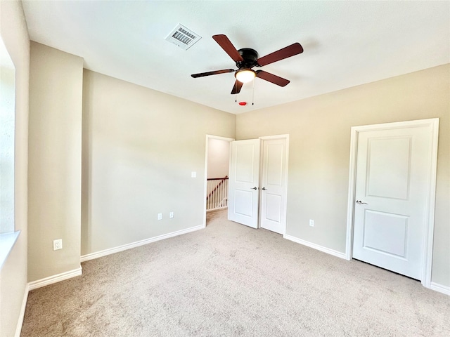 unfurnished bedroom featuring visible vents, carpet flooring, and baseboards