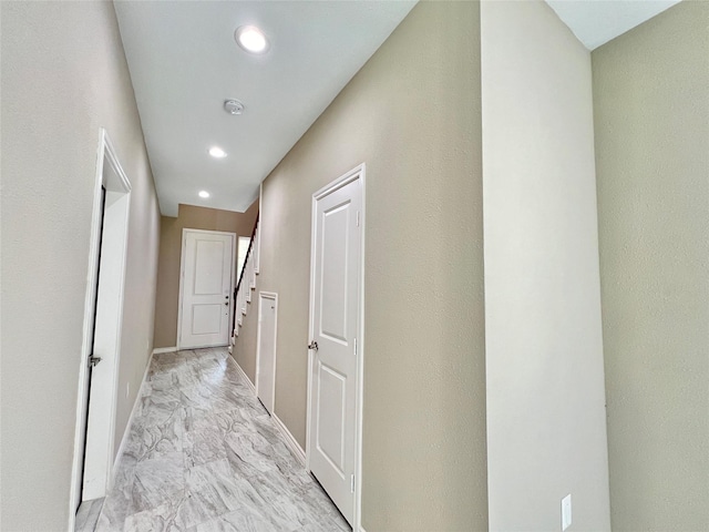 corridor featuring recessed lighting, baseboards, and marble finish floor