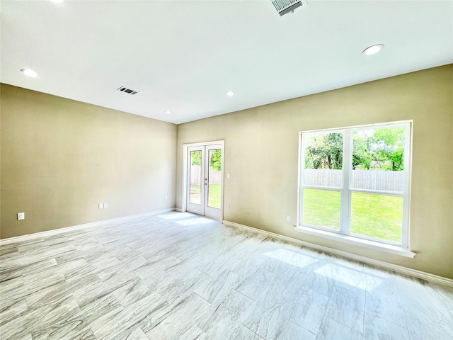 unfurnished room with recessed lighting, french doors, visible vents, and baseboards