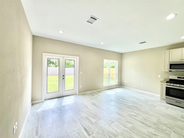 kitchen with white cabinetry, baseboards, visible vents, and appliances with stainless steel finishes