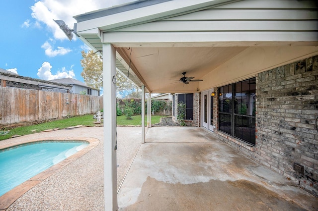 view of patio / terrace featuring a fenced in pool and ceiling fan