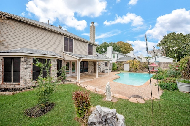 view of pool with a yard and a patio