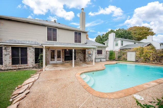 view of swimming pool featuring a patio and french doors