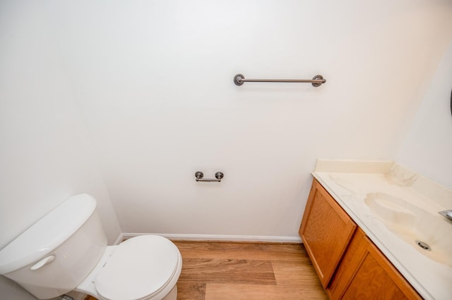 bathroom featuring vanity, toilet, and hardwood / wood-style floors