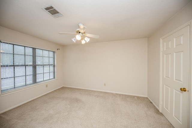 unfurnished room featuring light carpet and ceiling fan