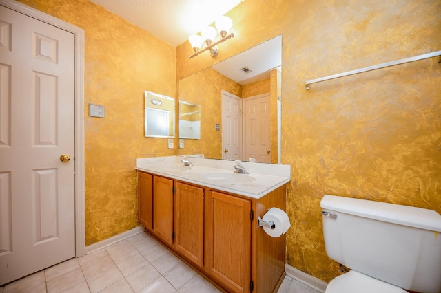 bathroom featuring vanity, toilet, and tile patterned flooring