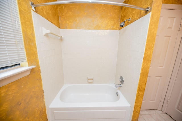 bathroom featuring tile patterned floors and tiled shower / bath combo