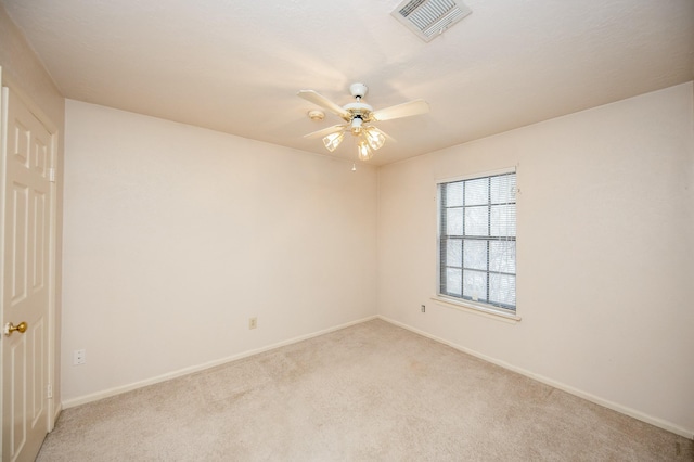 empty room with light colored carpet and ceiling fan