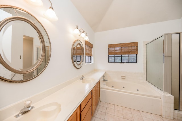 bathroom with tile patterned floors, separate shower and tub, vaulted ceiling, and vanity