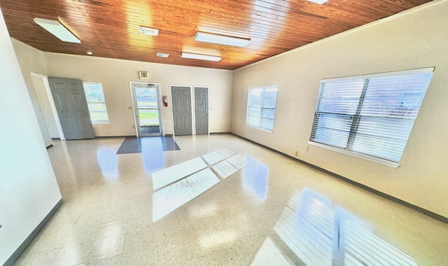 spare room with ornamental molding and wooden ceiling