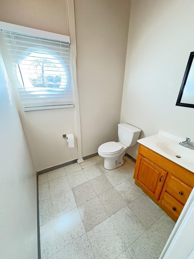 bathroom featuring tile patterned floors, vanity, and toilet