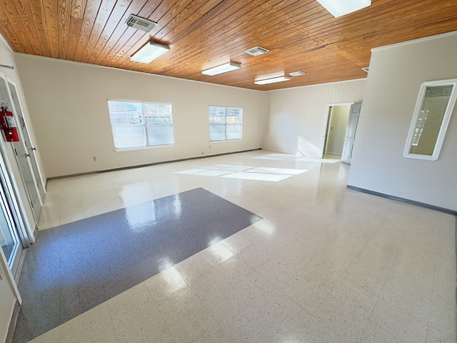 unfurnished room featuring tile patterned floors and wood ceiling