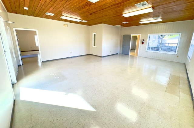 tiled empty room with wood ceiling