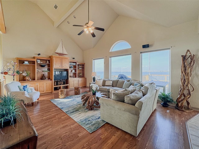 living room featuring ceiling fan, dark hardwood / wood-style flooring, high vaulted ceiling, and beamed ceiling