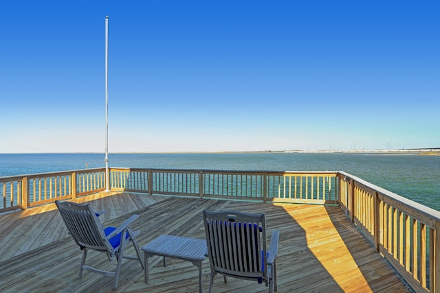 wooden terrace featuring a water view