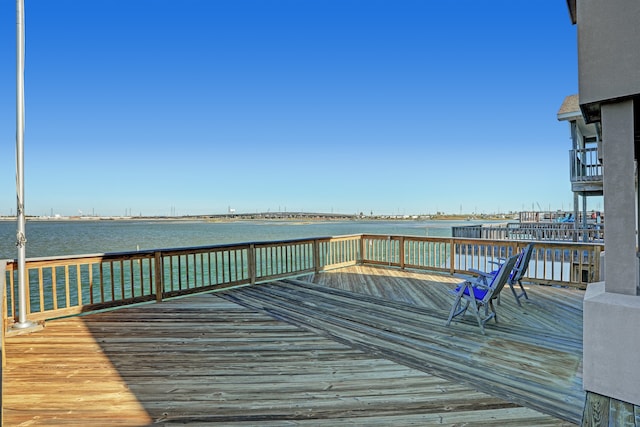 view of dock with a deck with water view