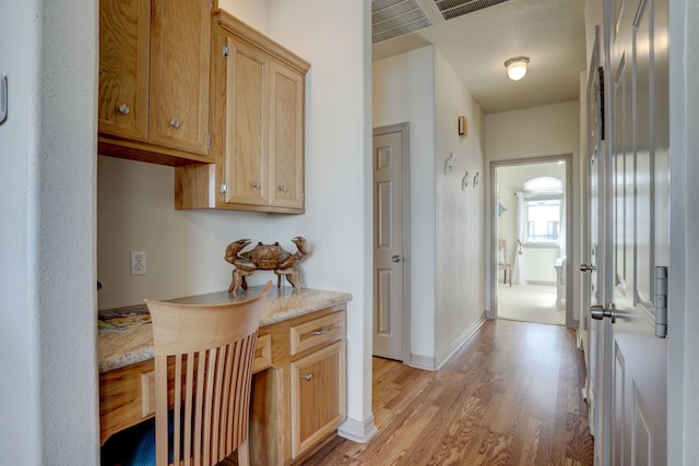 hallway with light hardwood / wood-style flooring