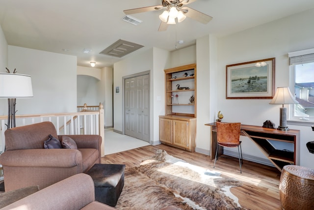 living room featuring ceiling fan and light hardwood / wood-style floors