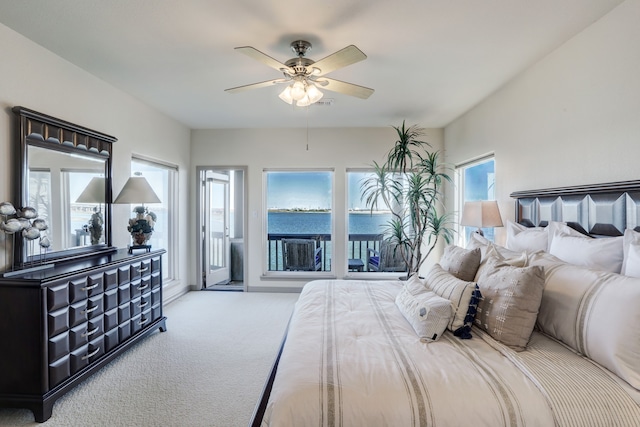 carpeted bedroom with access to outside, multiple windows, and ceiling fan