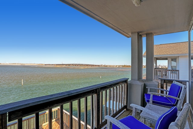 balcony featuring a water view