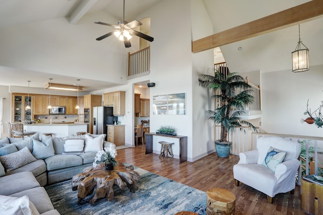 living room featuring ceiling fan, beamed ceiling, dark hardwood / wood-style floors, and high vaulted ceiling